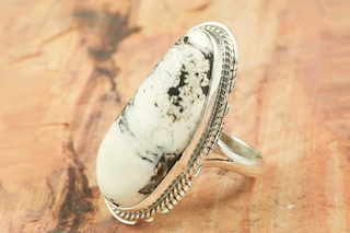 White Buffalo Turquoise set in Sterling Silver Ring. Beautiful Stone is formed from the minerals Calcite and Iron. It is mined near Tonopah Nevada. Created by Navajo Artist Larson Lee. Signed by the artist.